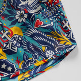 Close-up of colorful fabric featuring skulls, hearts, flowers, and eagles in a bold, vibrant pattern on Liberty Skull Silkies shorts.