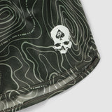 Close-up of dark green fabric with a contour line pattern and a white skull logo, part of the Topographic Silkies shorts design.