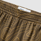 Close-up of olive green fabric with tan topographic contour lines and elastic waistband featuring a small label, showcasing the design details of Topographic Silkies.