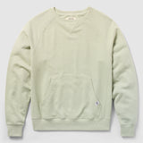 Smuggler French Terry Crew in a soft desert sage color, featuring long raglan sleeves, ribbed cuffs and hem, and a front kangaroo pocket with a small fabric tag.