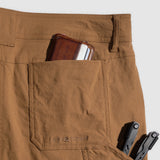 Close-up of coyote brown Field Shorts back pocket holding a brown wallet and a multitool with a light background.