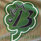 Lucky 13 Flag featuring a large green shamrock design with white outline and bold black number 13 on a patterned tan background
