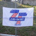 ZF Stars and Stripes Flag displayed on a chain link fence with a patriotic blue and red graphic, stars, Zero Foxtrot text, and Stay Zero slogan