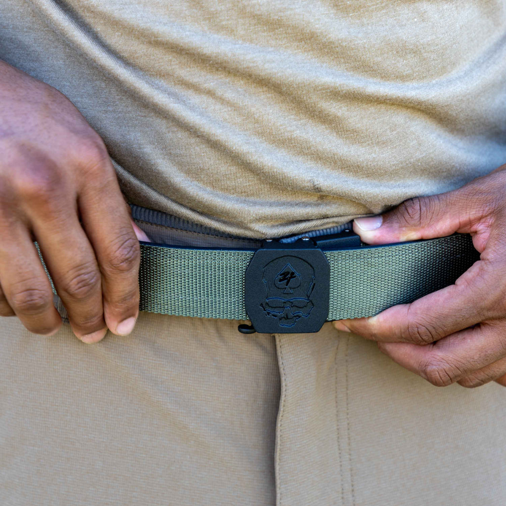 ZF x Kore Sleek Gun Belt fastened around the waist with a textured olive green strap and black buckle beneath a beige shirt