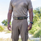 ZF x Kore Sleek Gun Belt worn with khaki tactical pants and a gray shirt in an outdoor setting, showing the belt buckle and adjustable design around the waist