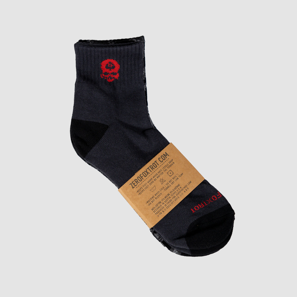 Pair of Zero Ankle Socks - Black Tiger Stripe and Grey featuring a low-cut design in black and grey with a red skull graphic near the cuff and a branded label around the ankle.