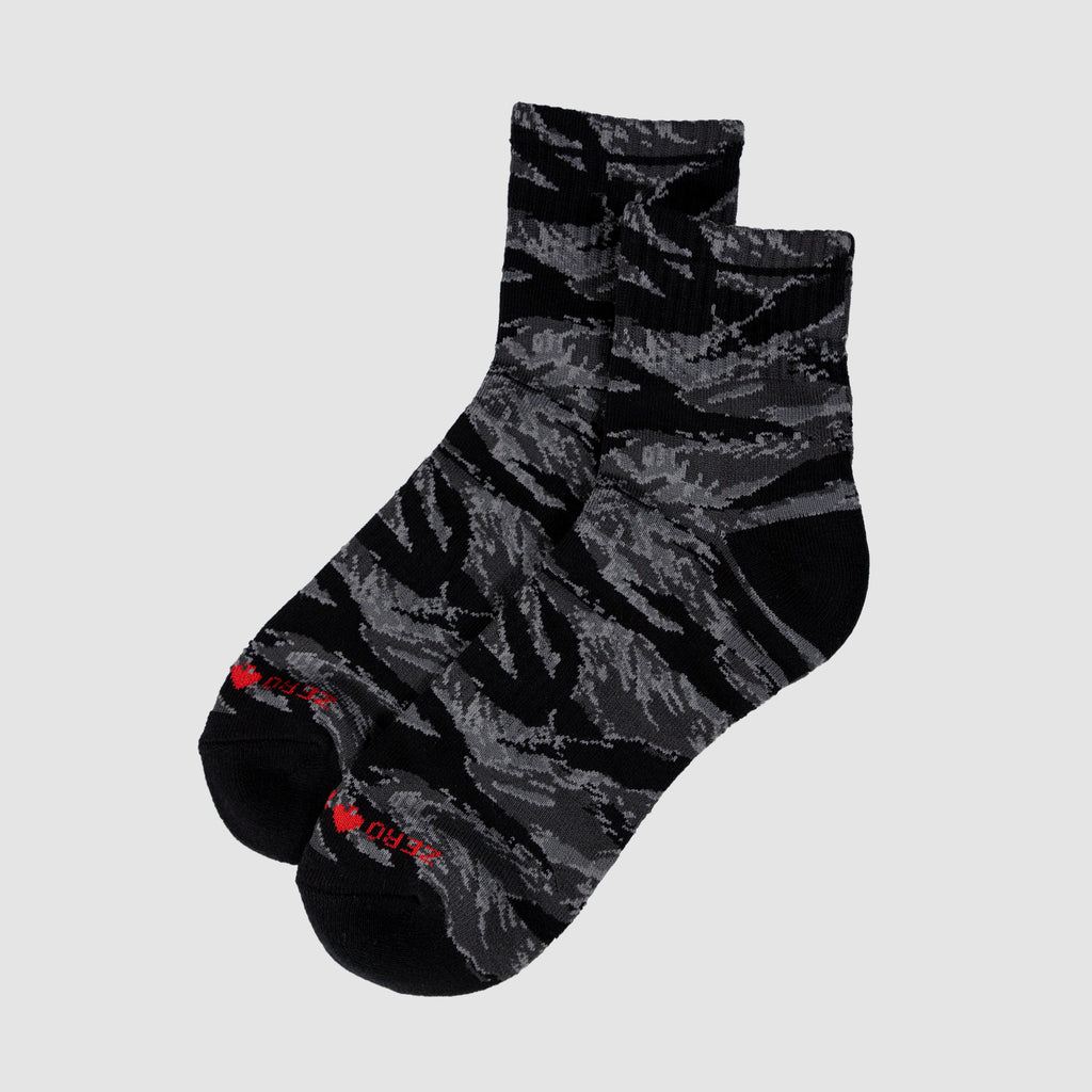 Pair of Zero Ankle Socks - Black Tiger Stripe and Grey featuring a black and grey tiger stripe pattern with a low-cut ankle design and red text detail on the toes.