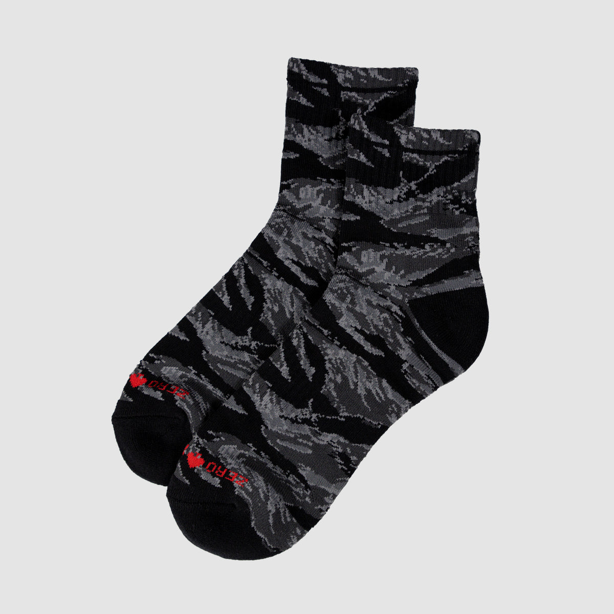 Pair of Zero Ankle Socks - Black Tiger Stripe and Grey featuring a black and grey tiger stripe pattern with a low-cut ankle design and red text detail on the toes.
