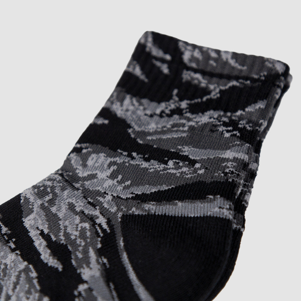 Close-up view of a pair of Zero Ankle Socks - Black Tiger Stripe and Grey featuring a black and grey tiger stripe pattern with ribbed ankle detail.