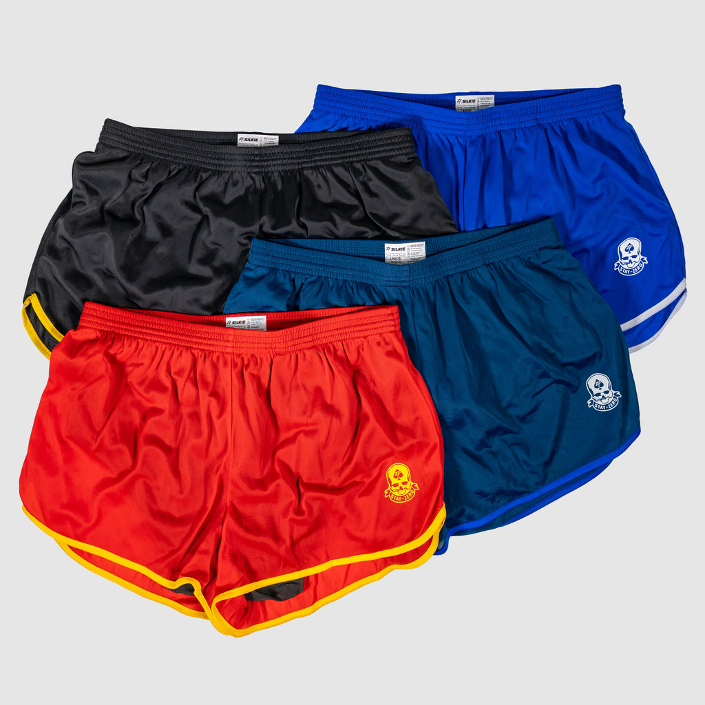 ZF Silkies - Branch Solids featuring four shiny solid-color Silkies shorts in black, royal blue, teal, and red with contrast trim and skull emblems