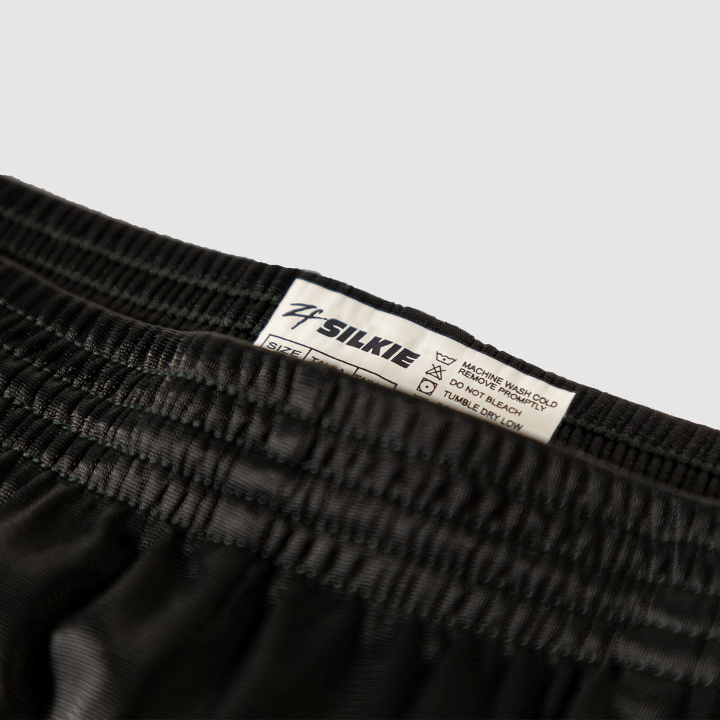 Close-up of black Silkies with an elastic waistband and sewn-in care label, from ZF Silkies - Branch Solids