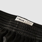 Close-up of black Silkies with an elastic waistband and sewn-in care label, from ZF Silkies - Branch Solids
