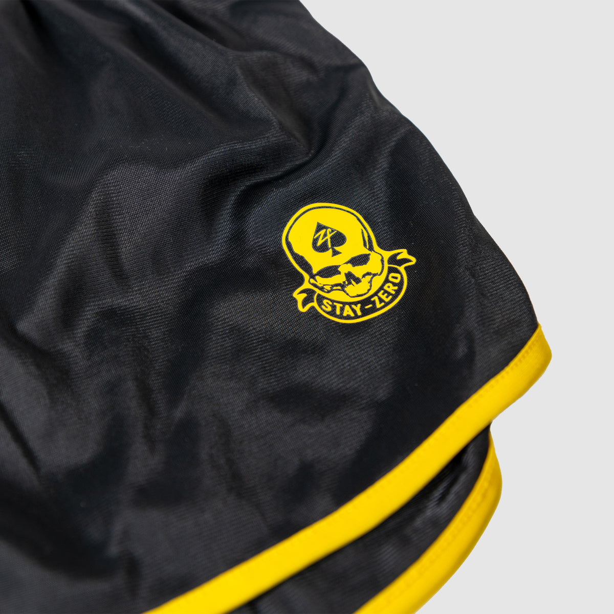 ZF Silkies - Branch Solids black silkies with bright yellow trim and a Stay Zero emblem on the fabric waistband edge