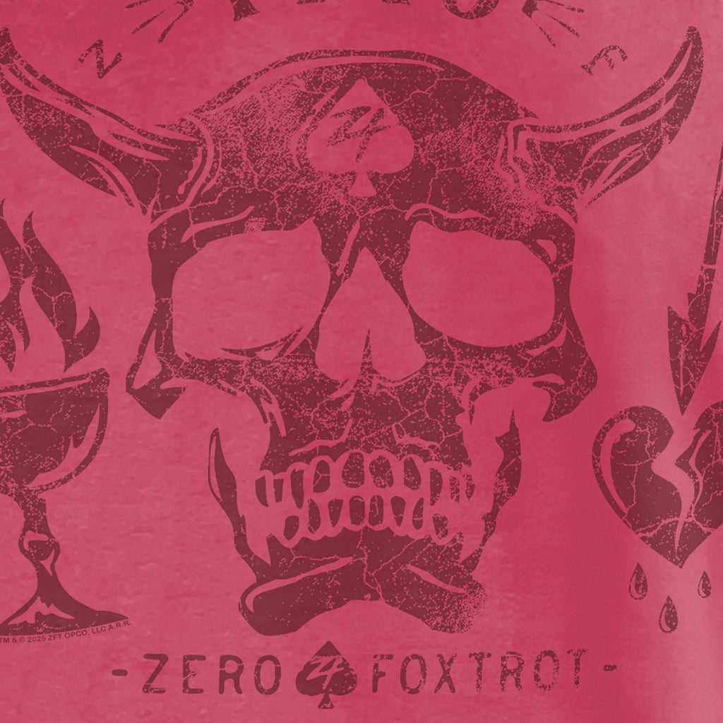 Close-up view of a distressed skull with horns and a spade symbol on the forehead, surrounded by stylized flames and hearts, printed on a red fabric of the Blackbeard 1718 Tee.
