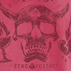 Close-up view of a distressed skull with horns and a spade symbol on the forehead, surrounded by stylized flames and hearts, printed on a red fabric of the Blackbeard 1718 Tee.