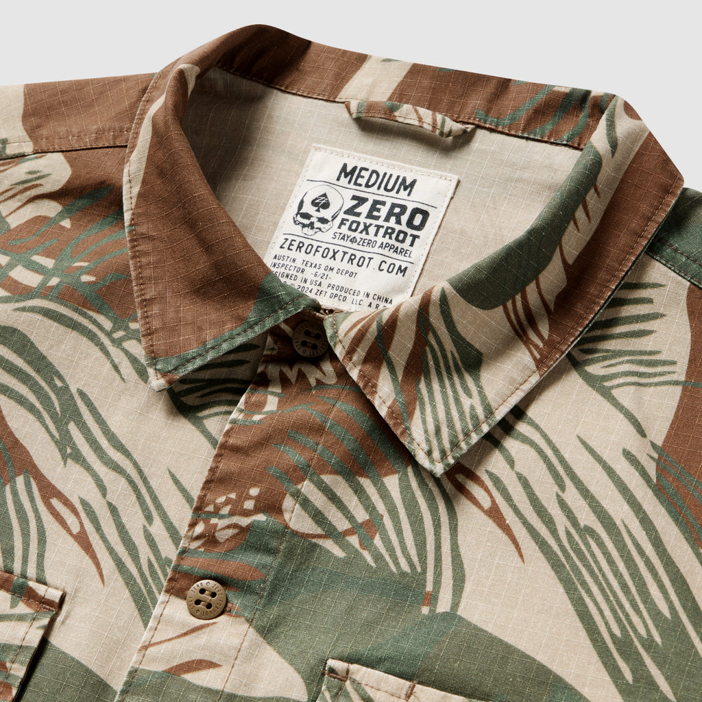 Close-up of a medium-sized CPO Shirt with a camouflage pattern in earth tones, featuring a buttoned collar and visible label inside the neckline.