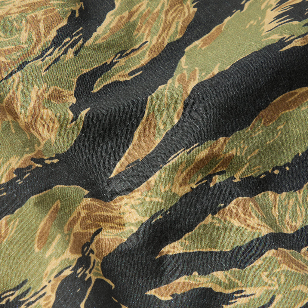Close-up of a green and gold tiger stripe camouflage pattern fabric on a CPO Shirt, highlighting the textured material and detailed print.