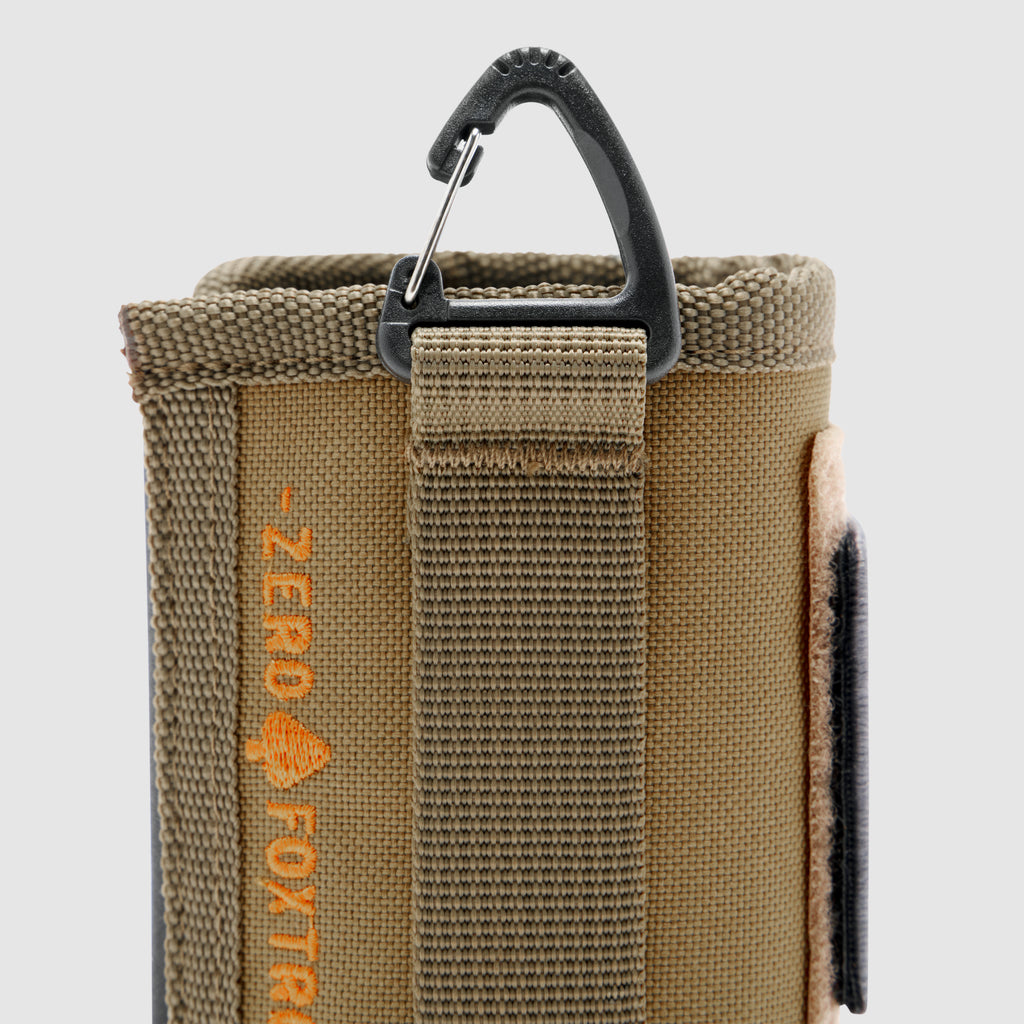 Close-up of a durable tan fabric Rations Drink Wrap with reinforced stitching and a black carabiner clip attached to a fabric loop for easy carrying and secure attachment.