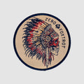 Chief Patch circular embroidered patch featuring a detailed profile of a feathered chief in navy red and tan with Zero Fox Trot text