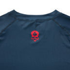 Compression Long Sleeve Rash Guard in navy with a red skull graphic on the chest and visible crew neckline stitching close up