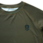 Compression Long Sleeve Rash Guard in olive green with crew neckline, flatlock stitching, and a small skull graphic on the chest