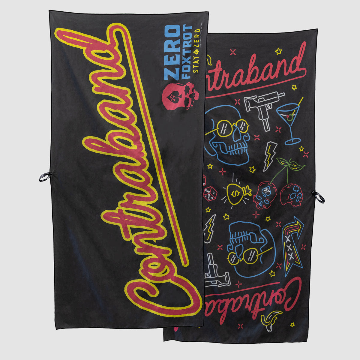 Two black microfiber beach towels (2025) featuring bold red and yellow Contraband text and colorful edgy graphics including skulls, guns, and cocktails.