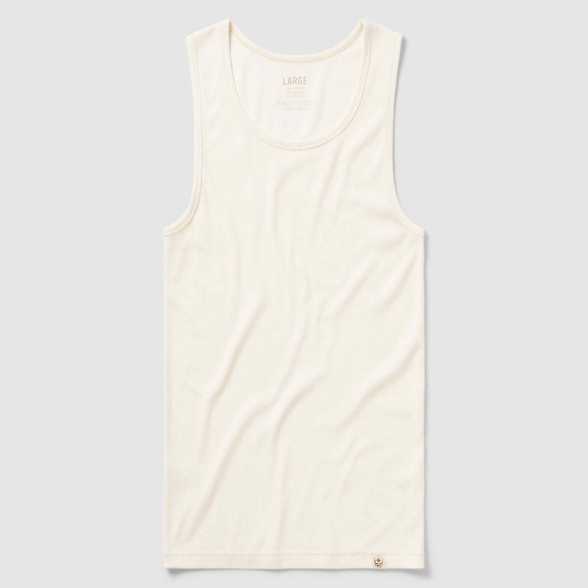 Skivvy Tank in off-white cotton fabric, sleeveless with a round neckline, laid flat on a light gray background.