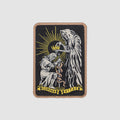 Crown of Life Patch featuring an embroidered crowned skull, winged figure, radiant sunburst, and Corona Vitae banner on a black background with tan border