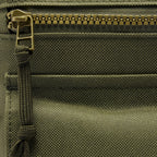 Surplus EDC Sling in olive green with a textured fabric interior, zippered compartment, and adjustable strap detail