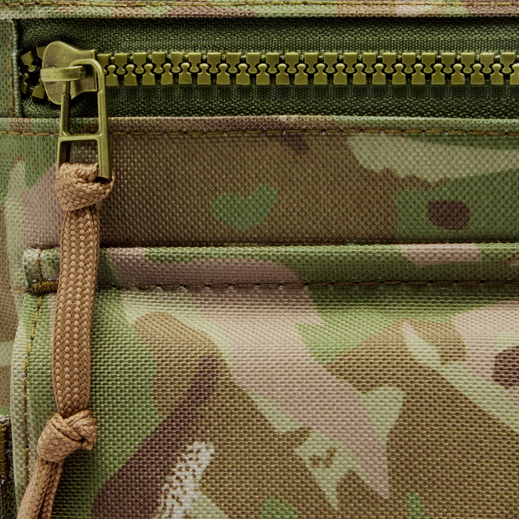 Surplus EDC Sling in camouflage fabric with a secure zipper closure and durable braided cord pull detail close up