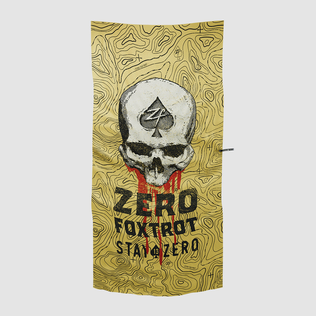 Microfiber Beach Towels featuring a bold skull design with an ace of spades symbol on the forehead, set against a topographic map background with the text "Zero Foxtrot Stay Zero.
