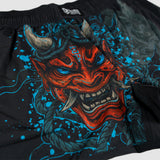 Close-up of black ZF Fight Shorts featuring a vibrant red Oni mask design with blue accents, sharp teeth, and detailed horns on the fabric.