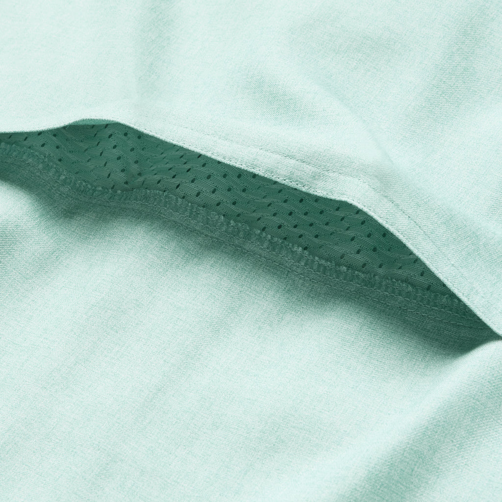 Close-up of the aqua-colored breathable mesh fabric detail under the hem of the F'n Soft Daily Shirt, highlighting its soft and lightweight material construction.