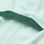 Close-up of the aqua-colored breathable mesh fabric detail under the hem of the F'n Soft Daily Shirt, highlighting its soft and lightweight material construction.