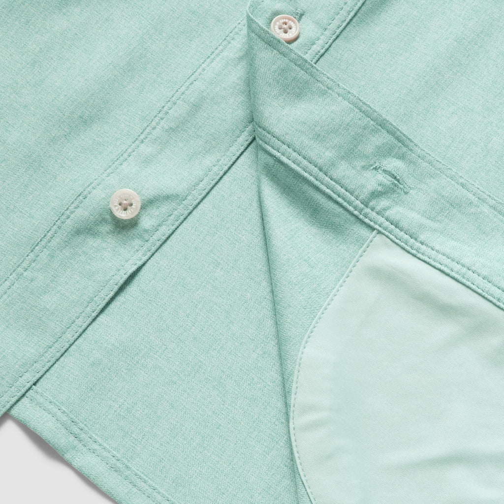 Close-up of aqua fabric with button detail and inner pocket lining on the F'n Soft Daily Shirt, showcasing soft texture and quality stitching.