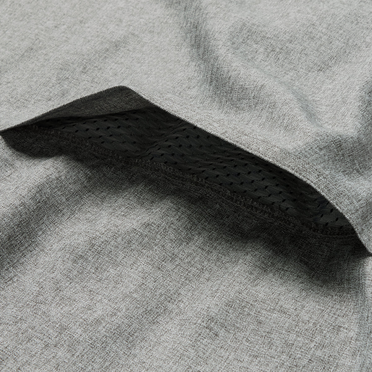 Close-up of the breathable mesh inner lining detail on a gray fabric of the F'n Soft Daily Shirt designed for comfort and ventilation.