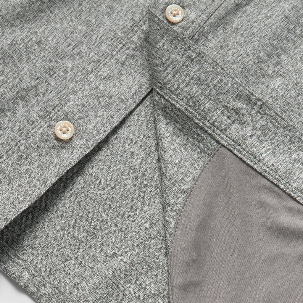 Close-up of a charcoal grey fabric button-up shirt showing detailed stitching and buttons, featuring the soft, comfortable lining of the F'n Soft Daily Shirt.