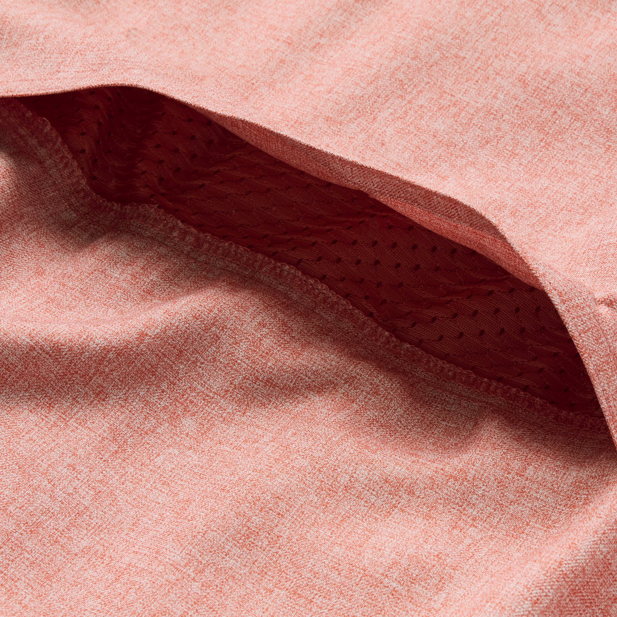 Close-up view of the textured fabric and inner mesh lining detail of the rust-colored F'n Soft Daily Shirt, highlighting its soft material and breathable construction.