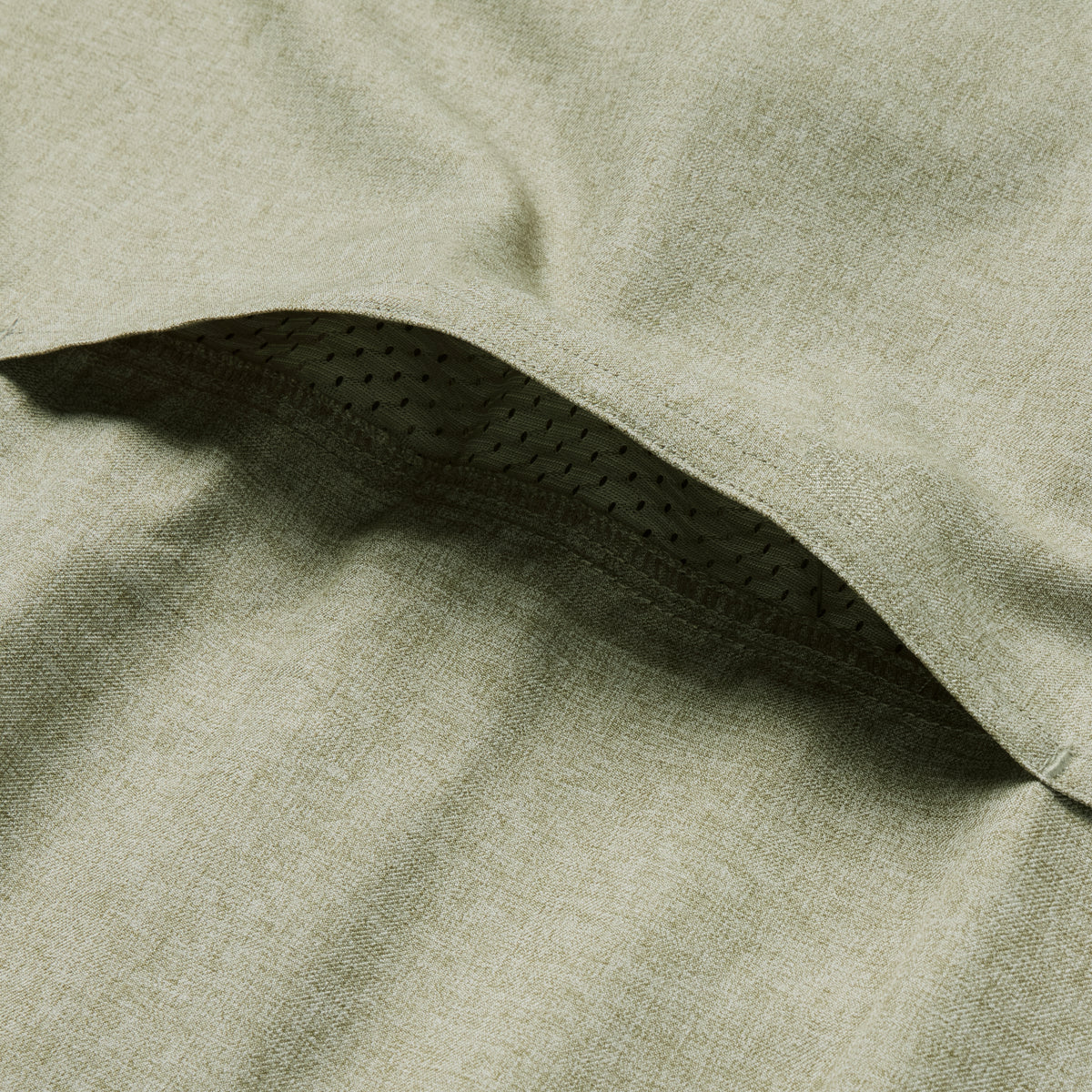 Close-up of the sage green F'n Soft Daily Shirt fabric showing a vent detail with breathable mesh lining for enhanced comfort and ventilation.