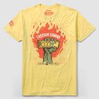 Yellow Freedom Banana Tee featuring a graphic of a raised fist holding a chocolate bar with flames in the background and text reading Freedom Banana Tee.