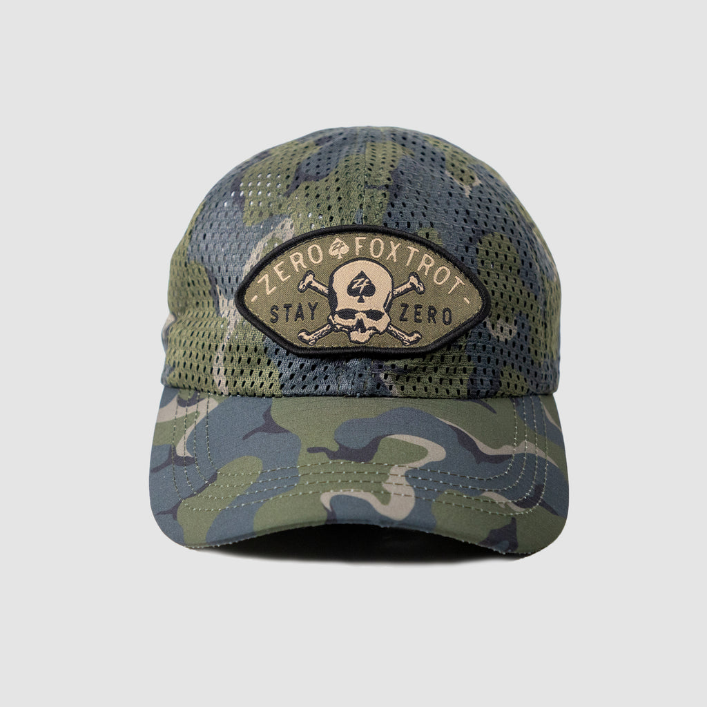 Full Mesh Cap with camouflage pattern and breathable mesh fabric, featuring an embroidered patch with a skull and crossbones design and the text "Zero Foxtrot Stay Zero.