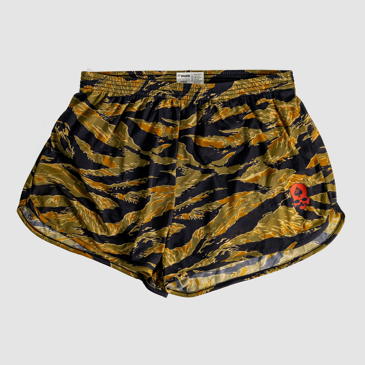 ZF Silkies - Camos featuring a tiger stripe camouflage pattern in gold and black with a small red skull detail, made from lightweight silk fabric with an elastic waistband.