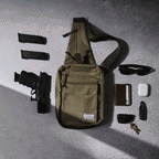 Surplus EDC Sling olive green crossbody bag displayed with adjustable strap, front pockets, handgun, magazines, sunglasses, phone, earbuds case, knife, and keys