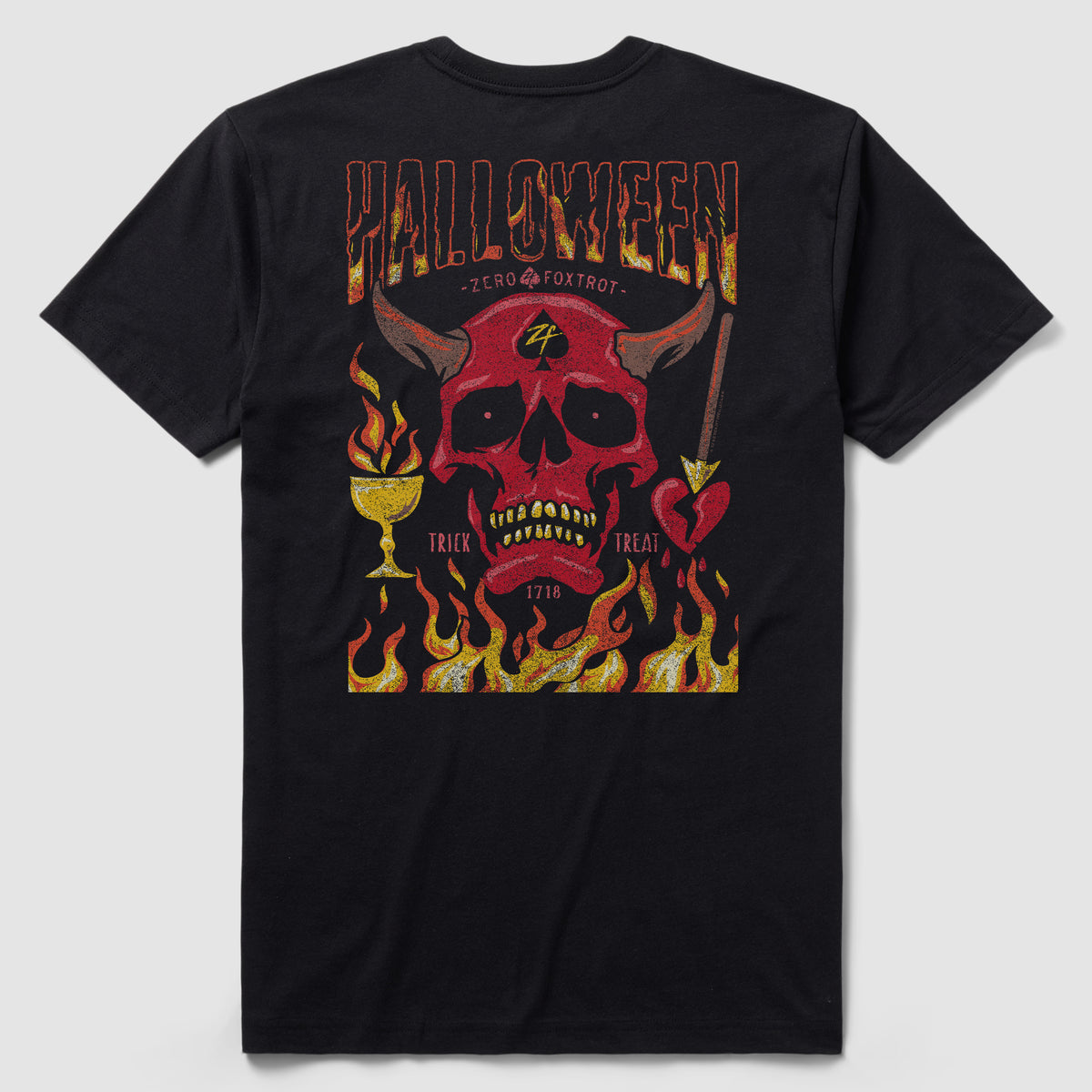 Back view of a black Halloween No Quarter Tee featuring a red skull with horns, flames, a chalice, an arrow-pierced heart, and decorative text reading "Halloween" and "Trick or Treat" in fiery colors.