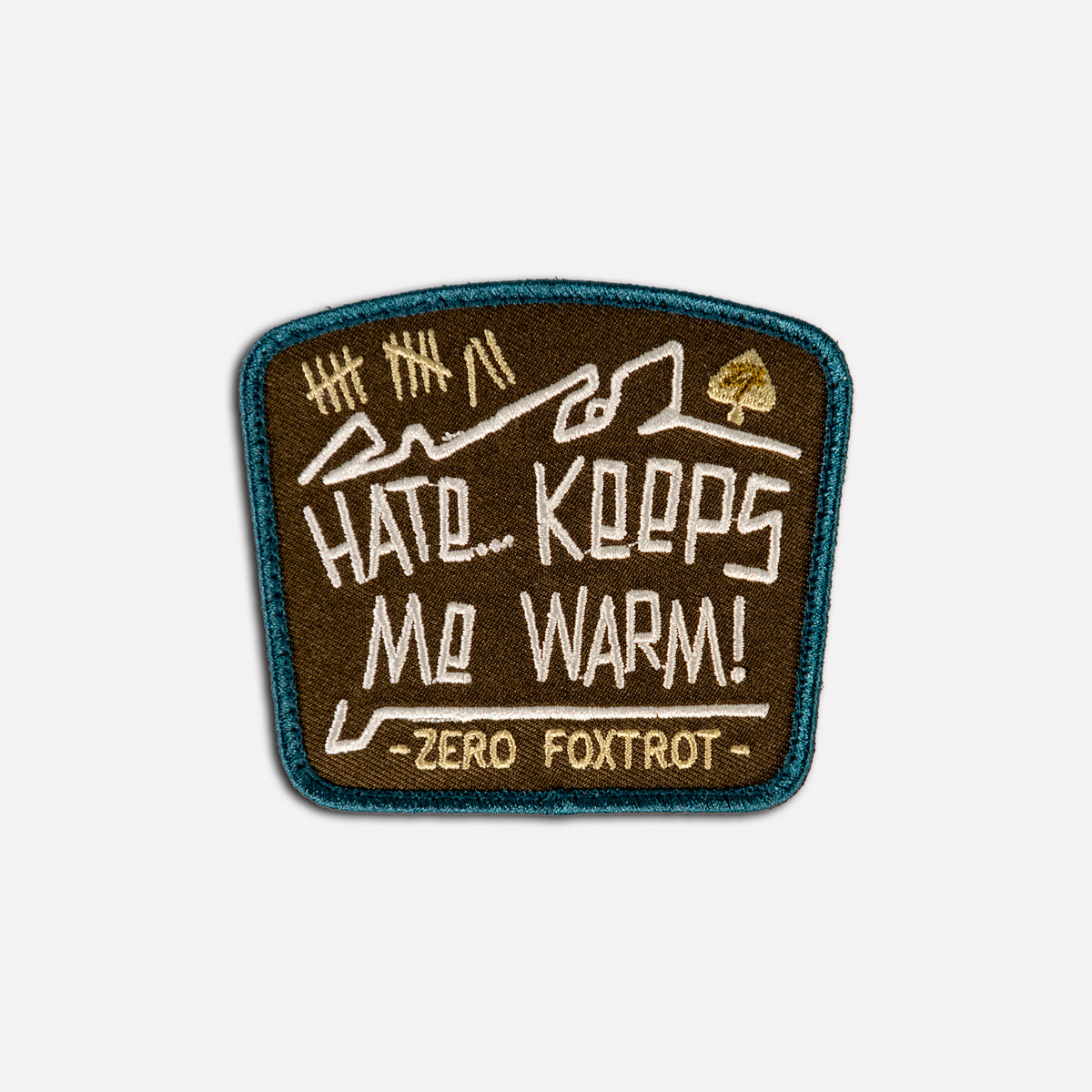 Keeps Me Warm Patch embroidered brown and teal patch with mountain artwork and the words Hat Keeps Me Warm and Zero Foxtrot