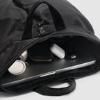 ZF Flyers Helmet Bag in black, shown open with a laptop, wireless earbuds, case, and accessories inside, featuring zippered compartments and carry handles