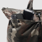 ZF Flyers Helmet Bag close-up in camouflage fabric with a smartphone and black case stored in its front pocket