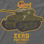 Close-up detail of a graphic on the Hula Tank featuring a green military tank with a woman in a hula skirt and flower lei dancing atop the turret, accompanied by yellow text that reads "ZERO FOXTROT STAY ZERO.