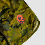 Close-up of camo patterned fabric with green and brown tones featuring a bright red skull logo detail on the edge of a garment titled ZF Silkies - Camos.