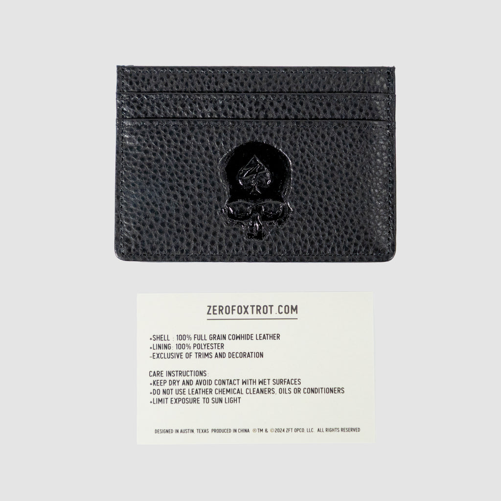Black textured Leather Cardholder with embossed spade design on front, showing multiple card slots and a care instruction card below.